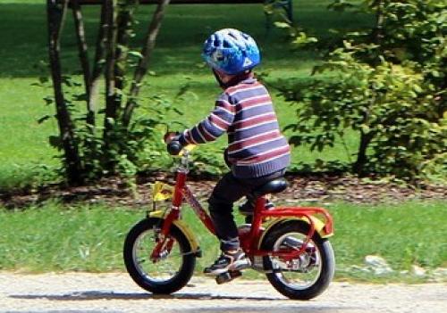 A child is riding a bicycle along a path.